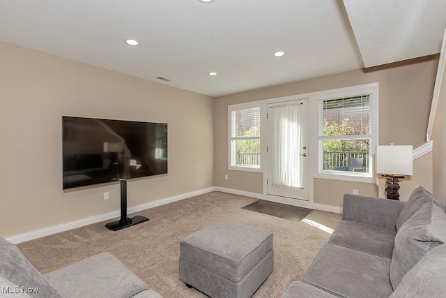 living room featuring recessed lighting, baseboards, and carpet floors