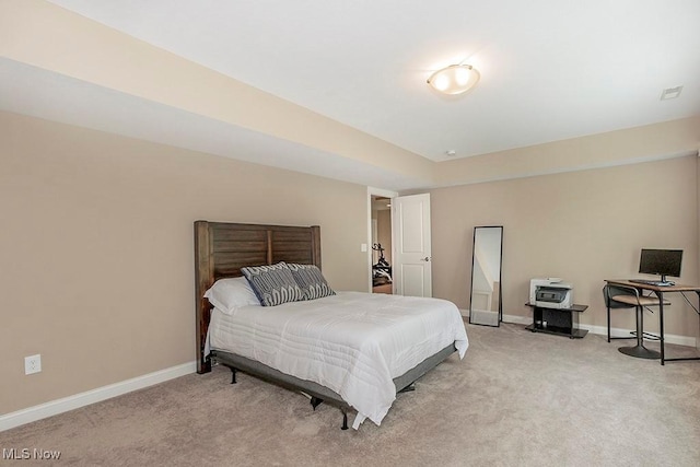 bedroom featuring visible vents, light colored carpet, and baseboards