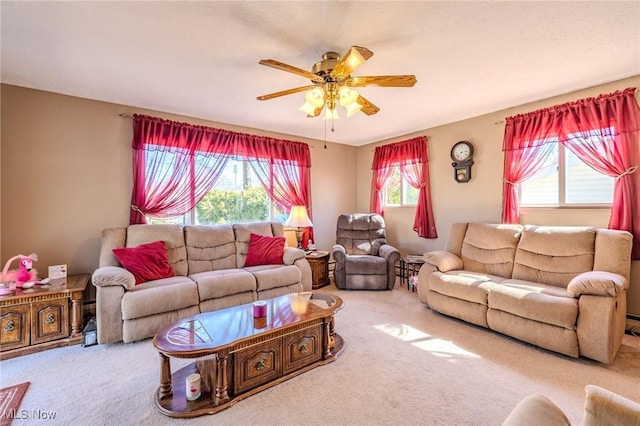 living area with carpet floors and ceiling fan