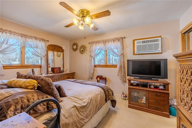 carpeted bedroom featuring ceiling fan and a wall mounted AC