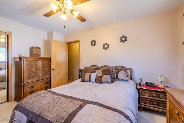 bedroom featuring light carpet and a ceiling fan