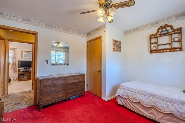 bedroom with a ceiling fan, dark carpet, and a wall unit AC