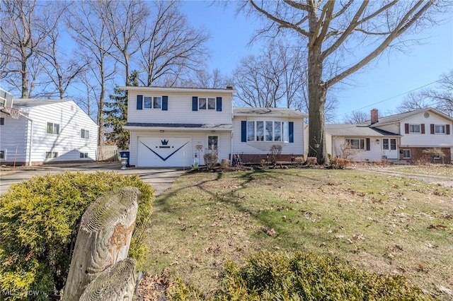 tri-level home featuring a garage, a chimney, concrete driveway, and a front lawn