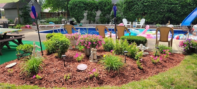 outdoor pool with a patio area and fence