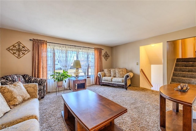 living room featuring stairway and carpet