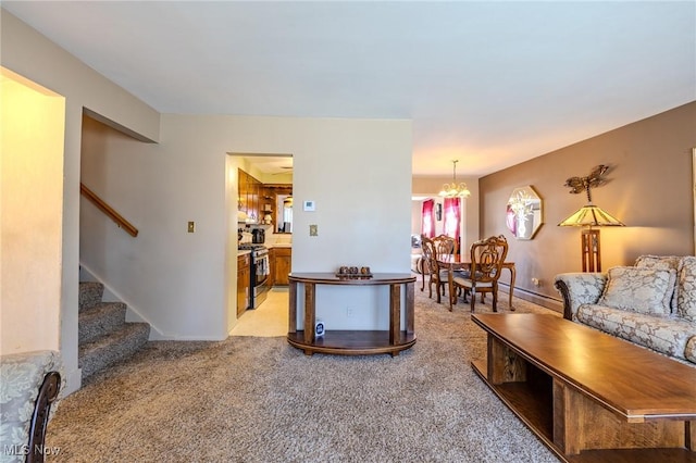 living area with baseboards, light colored carpet, a chandelier, and stairs