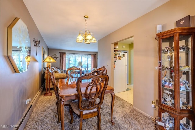 dining area featuring carpet, baseboards, and a chandelier