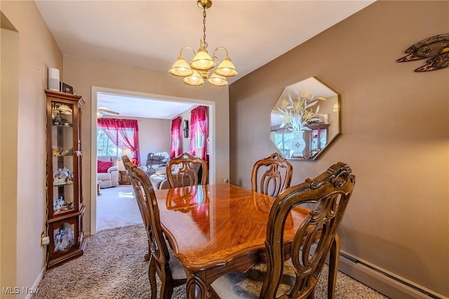 carpeted dining area featuring a chandelier, a baseboard heating unit, and baseboards