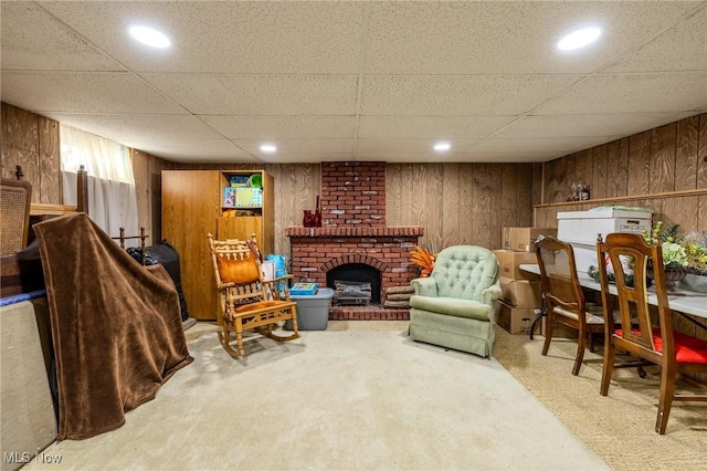 living area with recessed lighting, a fireplace, wood walls, and carpet floors