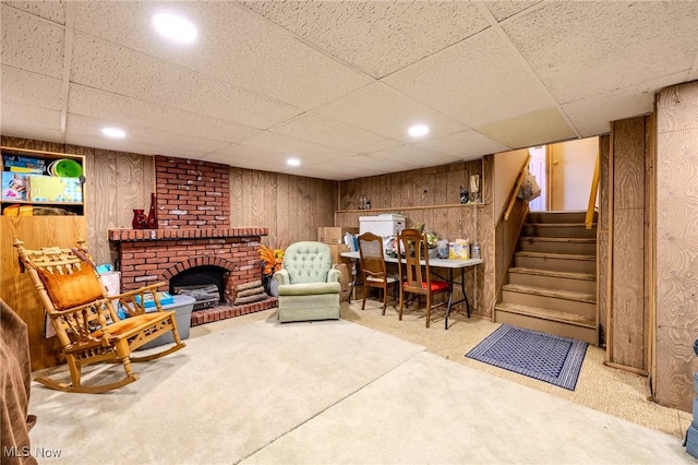 living area featuring stairway, wooden walls, carpet, and recessed lighting