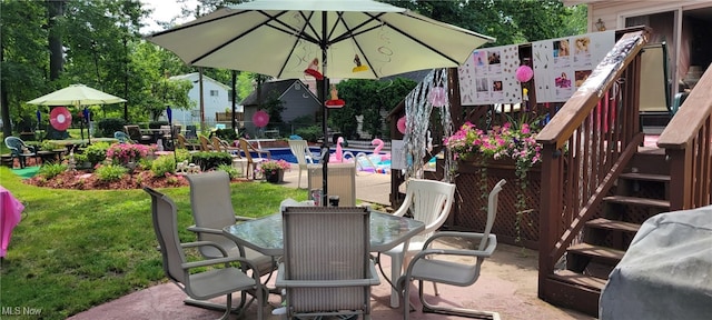 view of patio / terrace featuring stairs and outdoor dining area