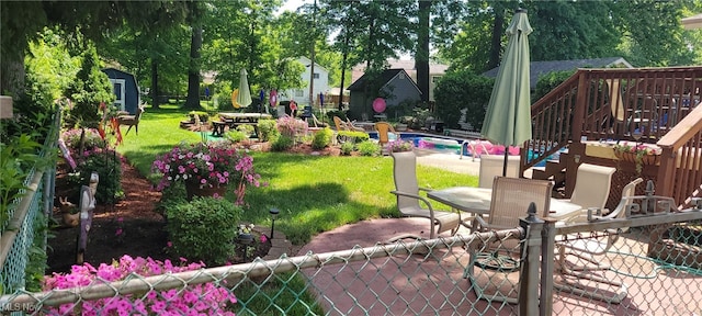 exterior space with fence, a lawn, outdoor dining area, a patio area, and an outbuilding