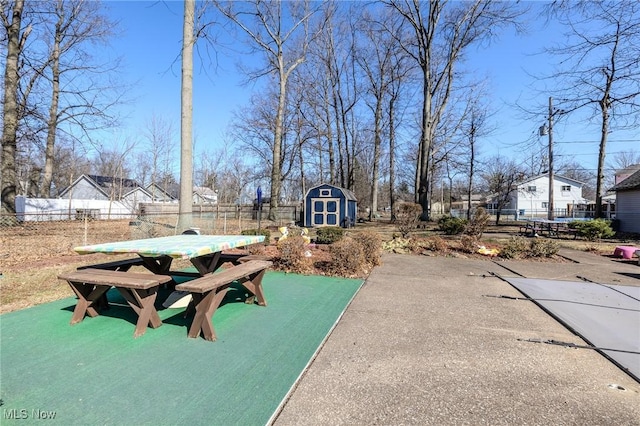 surrounding community with an outdoor structure, a storage unit, and fence private yard