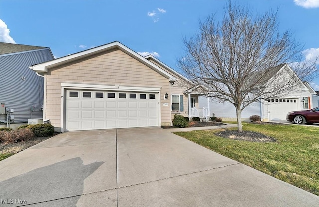 single story home with an attached garage, concrete driveway, and a front lawn