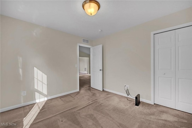 unfurnished bedroom with a closet, visible vents, baseboards, and carpet floors