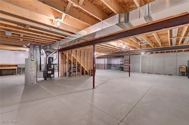 unfinished basement with heating unit and water heater