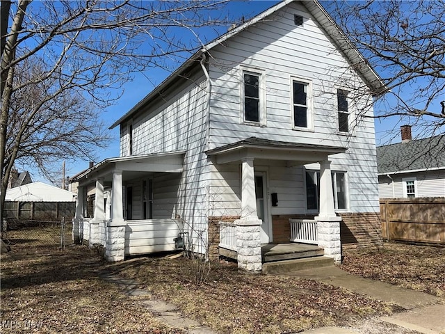 view of front of house with covered porch and fence