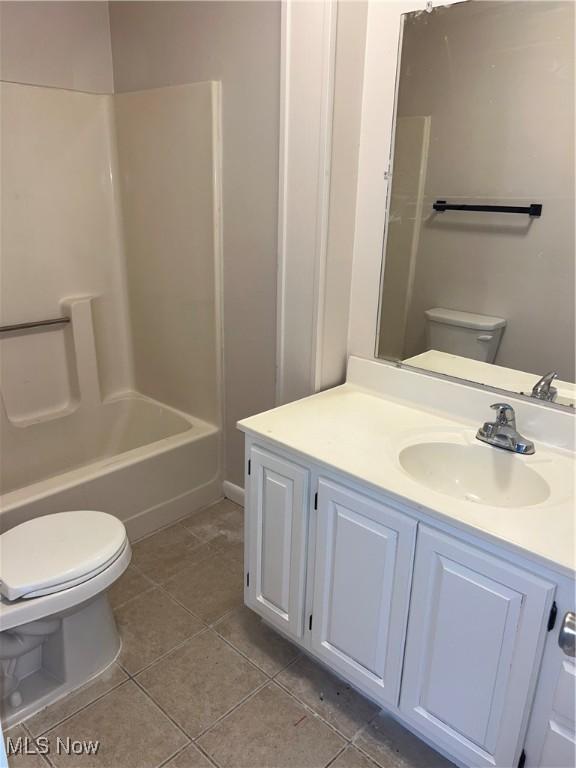 full bath with tile patterned flooring,  shower combination, toilet, and vanity