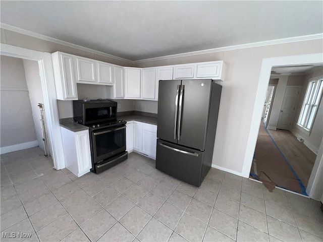 kitchen with light tile patterned floors, ornamental molding, black appliances, white cabinetry, and dark countertops