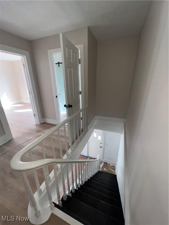 staircase featuring baseboards