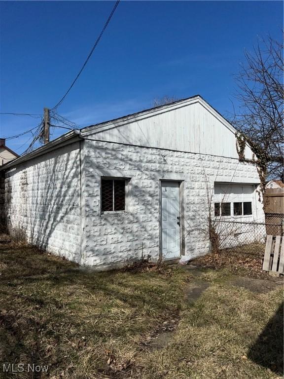 back of house featuring fence