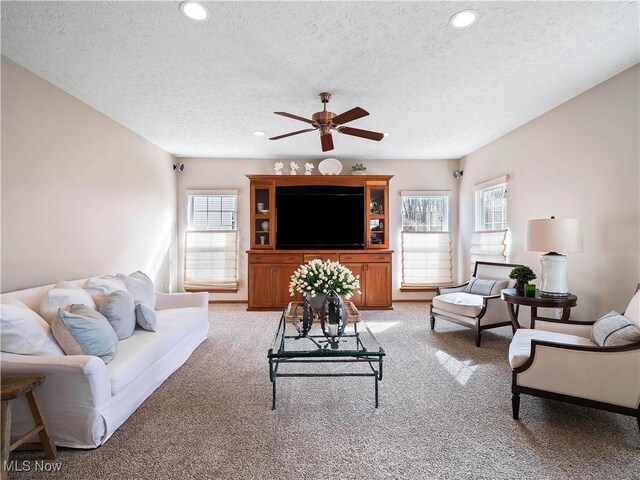 living room featuring ceiling fan, recessed lighting, and light carpet