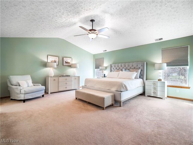 bedroom featuring visible vents, ceiling fan, lofted ceiling, and carpet