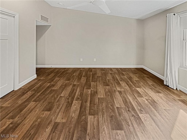 interior space with visible vents, ceiling fan, baseboards, and wood finished floors