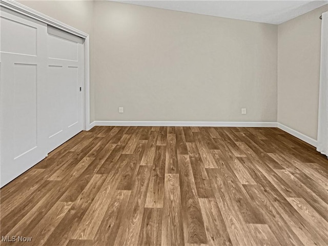 unfurnished bedroom featuring baseboards and wood finished floors