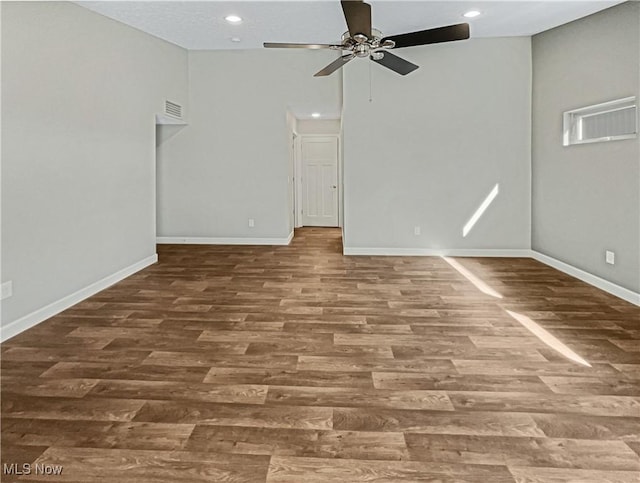 spare room with visible vents, baseboards, a ceiling fan, and wood finished floors