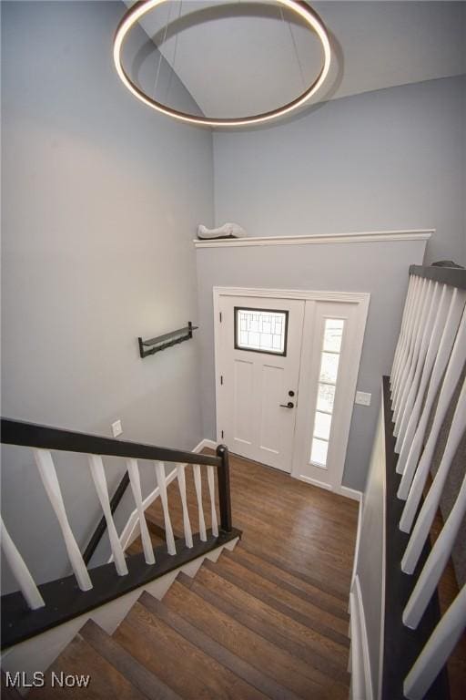 foyer entrance with wood finished floors and stairs