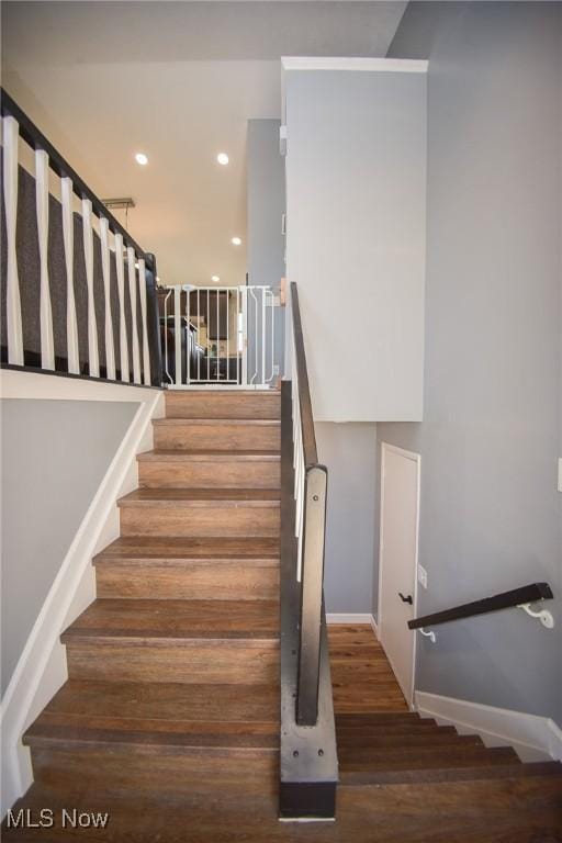 stairs with recessed lighting, baseboards, and wood finished floors