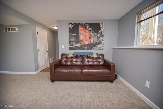 carpeted living room with visible vents and baseboards