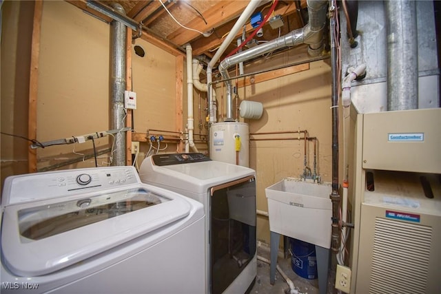 laundry area with water heater, laundry area, and washing machine and clothes dryer