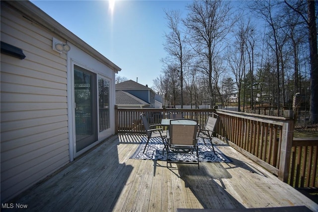 wooden terrace with outdoor dining area