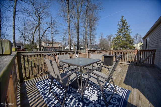 wooden terrace with outdoor dining space