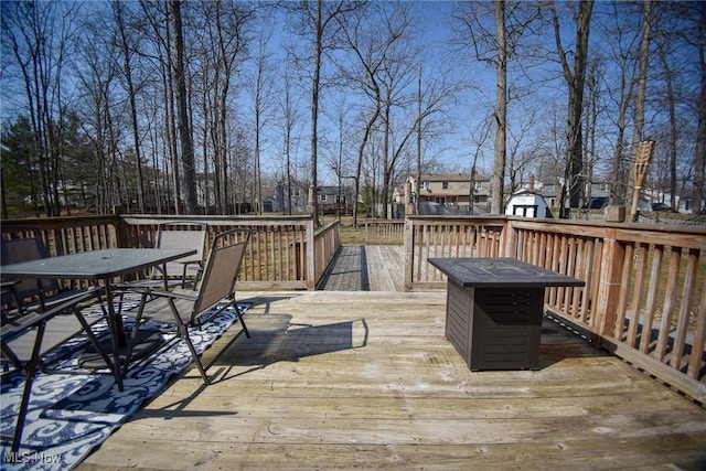 wooden terrace featuring outdoor dining space