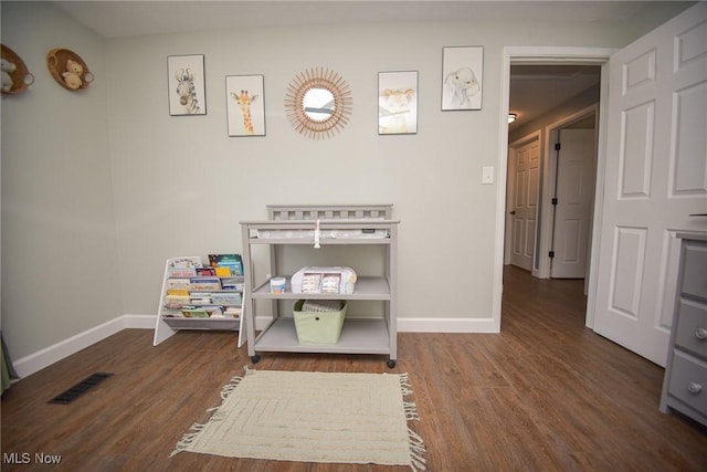 playroom featuring visible vents, baseboards, and wood finished floors