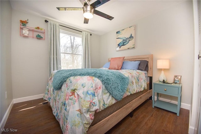 bedroom with ceiling fan, baseboards, and wood finished floors