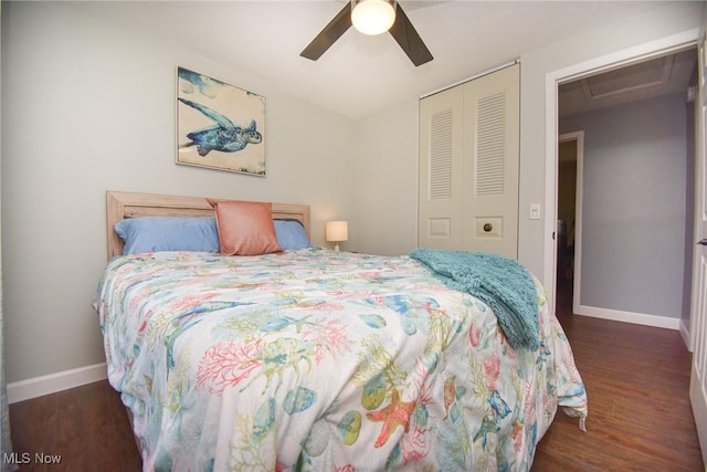 bedroom featuring a closet, baseboards, and wood finished floors