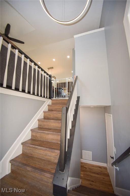 stairs with recessed lighting, visible vents, baseboards, and wood finished floors