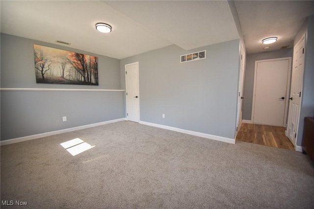 unfurnished room with visible vents, baseboards, and carpet