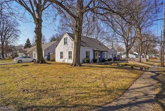 exterior space featuring a garage and a front lawn