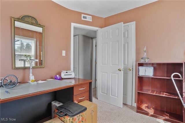 home office featuring visible vents and light carpet