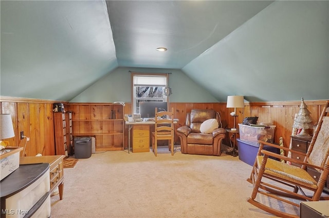 carpeted home office with lofted ceiling and wood walls