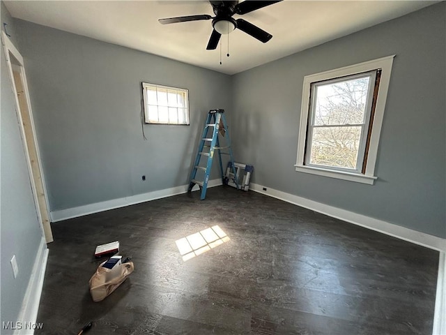 empty room with baseboards and ceiling fan