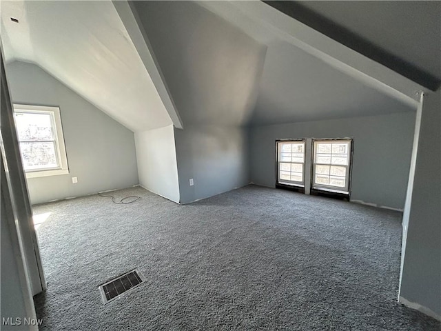 bonus room featuring visible vents, carpet flooring, plenty of natural light, and lofted ceiling