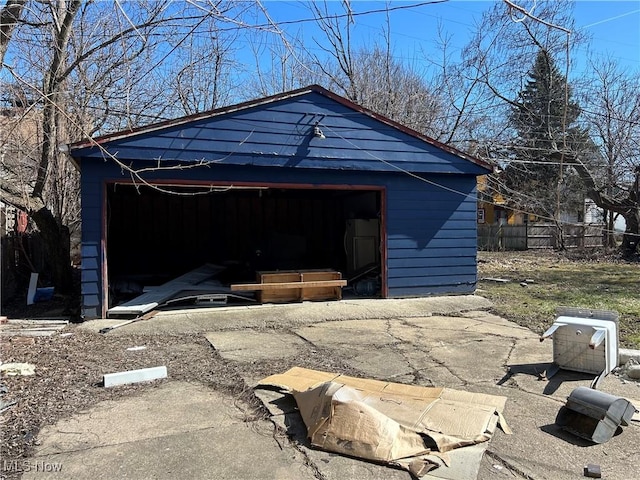 view of outdoor structure featuring an outbuilding and fence