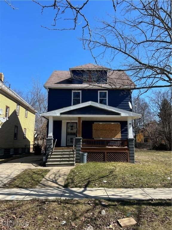 american foursquare style home with brick siding and a porch