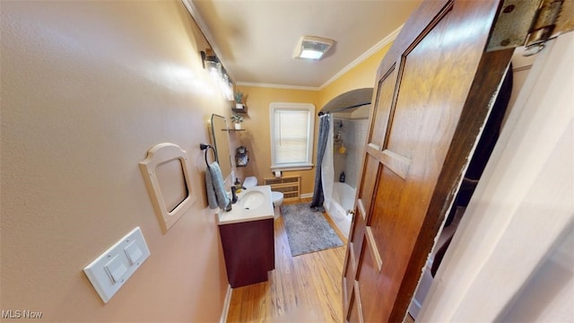 bathroom with vanity, wood finished floors, crown molding, and shower / bath combination with curtain